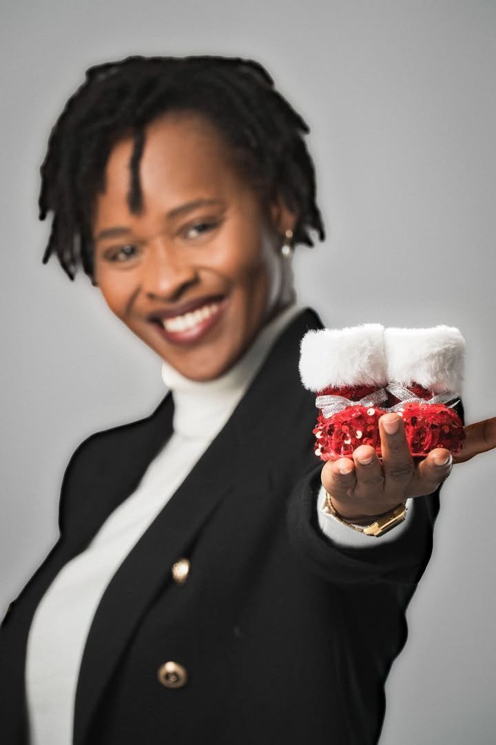 Adjoua Laetitia Konan holding a pair of baby booties