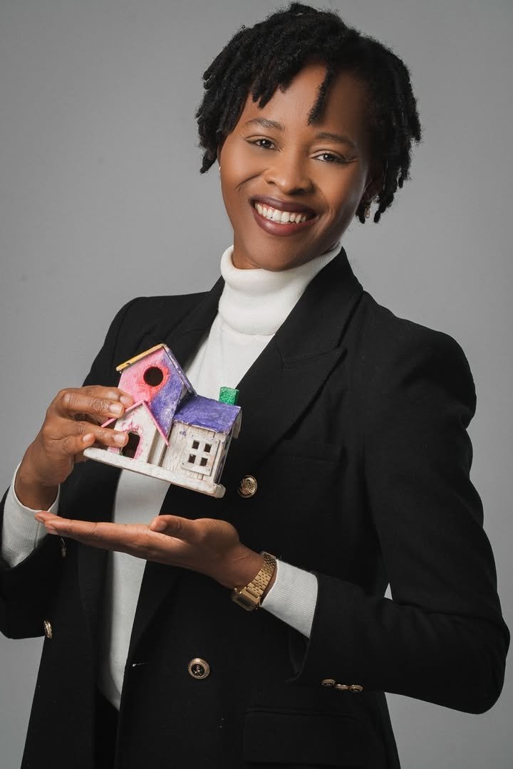 Adjoua Laetitia Konan presenting a small model house